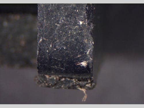 A close-up view of a single-phase motor starter, with asbestos fibers visible.