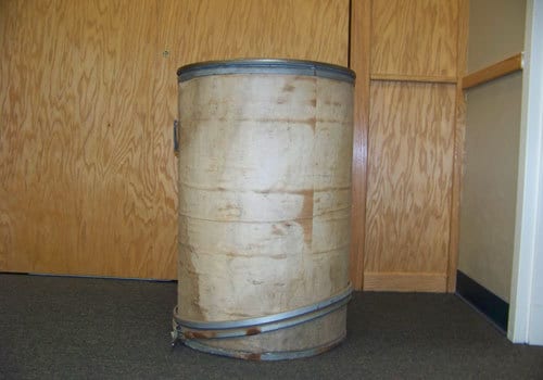 Cardboard drum utilized to hold asbestos-containing plastic molding compound
