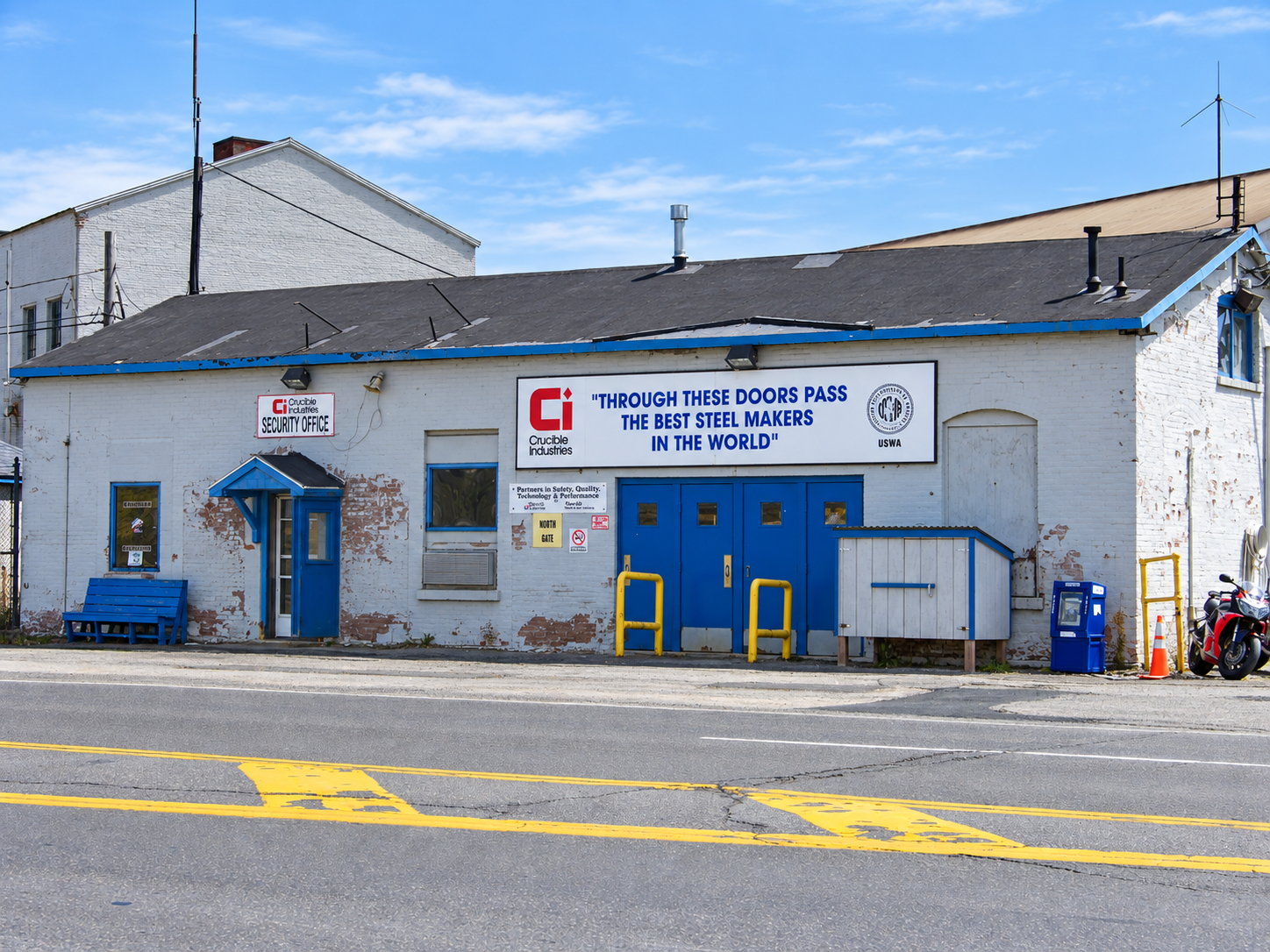Crucible Industries entrance with blue doors and the steel makers sign above the doorway